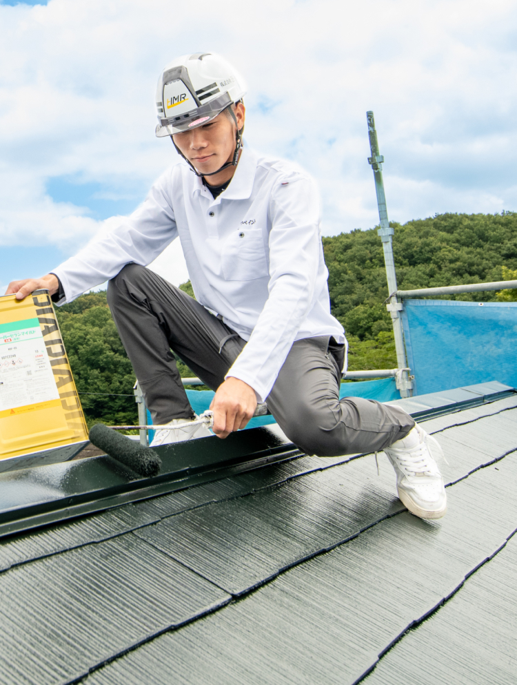 ローラーで屋根を塗装している様子